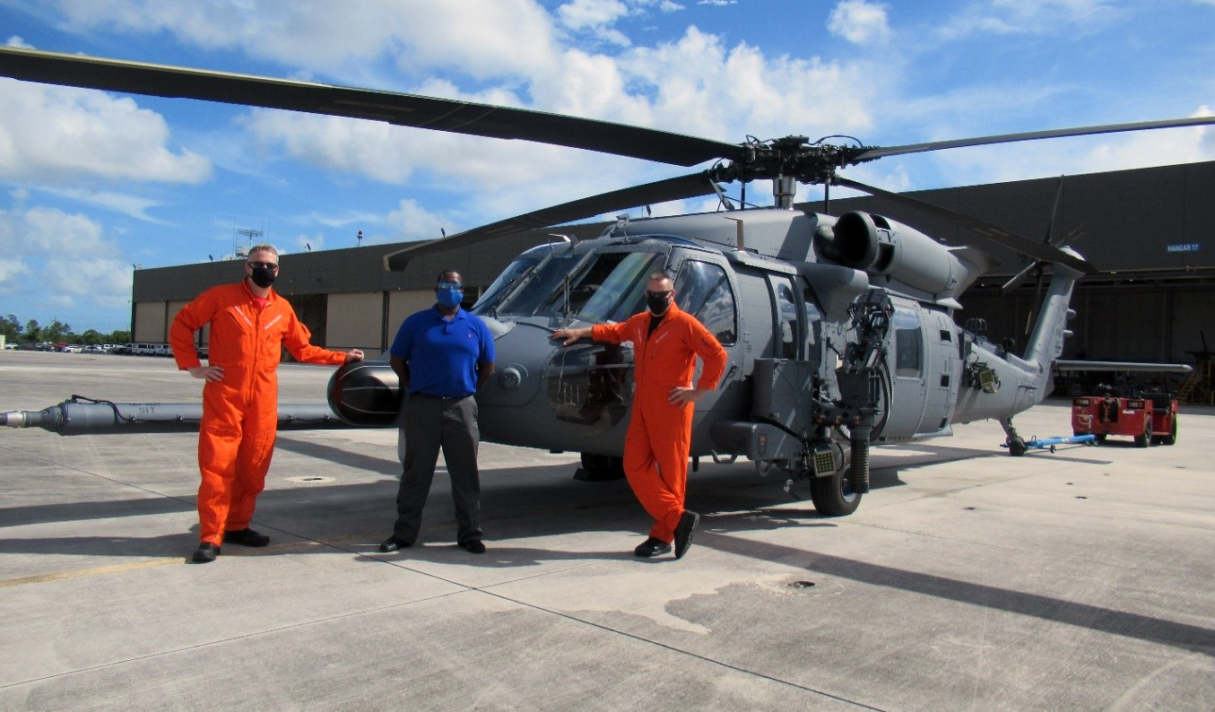 Sikorsky Pilots Bob Arsenault and Ben Williamson with Julian Cox, hangar manager, pose with the Air Force’s Jolly Green II